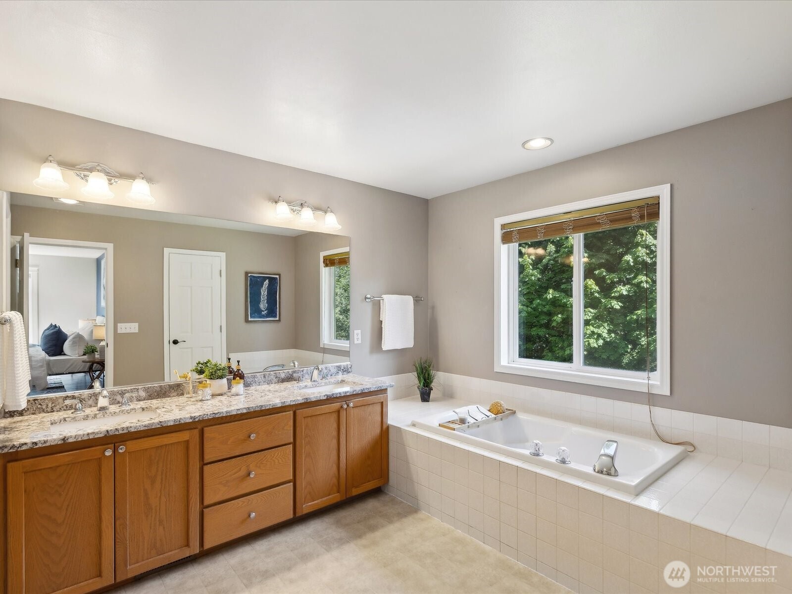 Remodeled laundry room with overhead cabinets & a utility sink