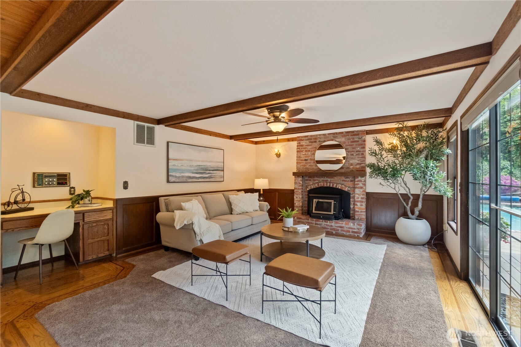 Light-filled casual living room with slider on the right and built-in desk on the left.