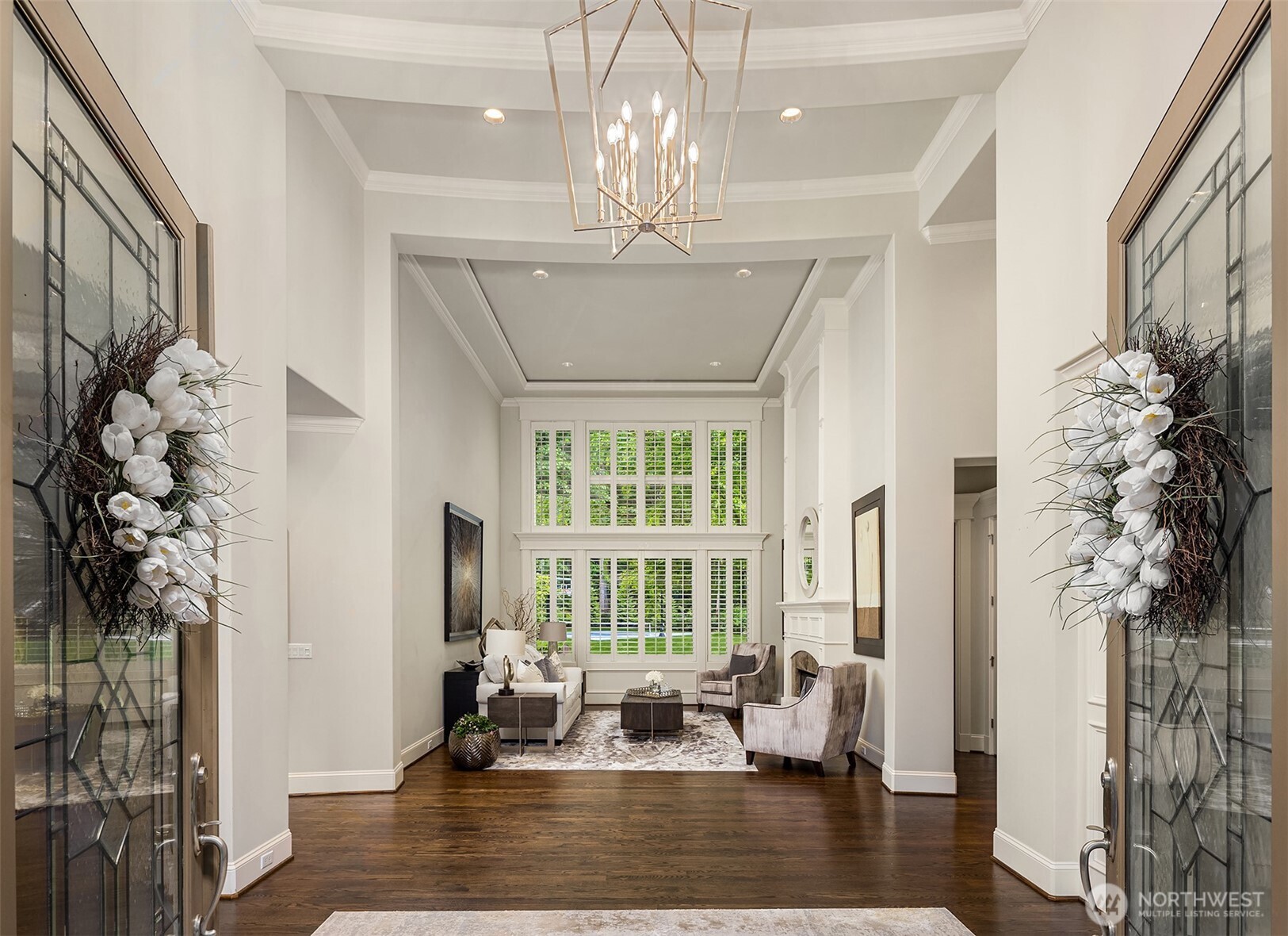 Stained glass sidelights, transom, and doors. In this picture, den is on the left and dining room is on the right. Private den with double glass doors and dining room encompass spacious foyer.
