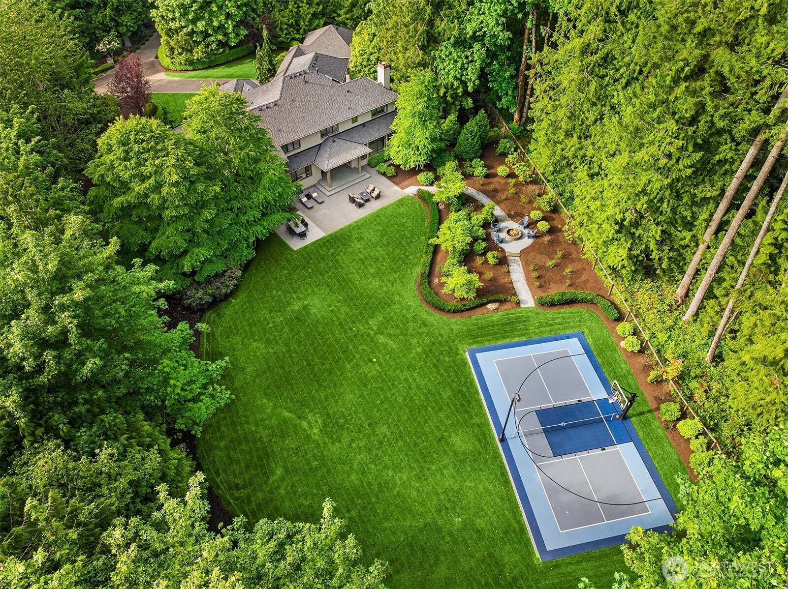 Entertainment sized patios with multiple interconnected spaces. Sport court for pickleball (our fastest growing sport in America) and basketball and many other sports! Huge, level yard for activities of all kinds. All surrounded by wooded privacy and the natural splendor.