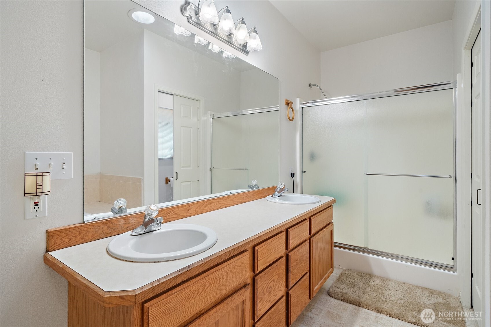 Dual Vanity's, soaking tub and a privy in the Primary