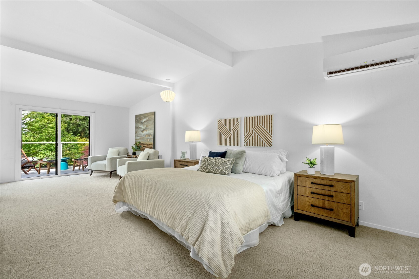 Oversized primary bedroom with a mini-split for cooling, sitting area, and deck.
