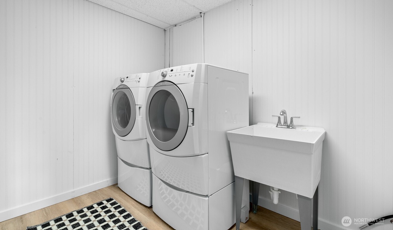 Laundry room on the lower level with newer front load machines.