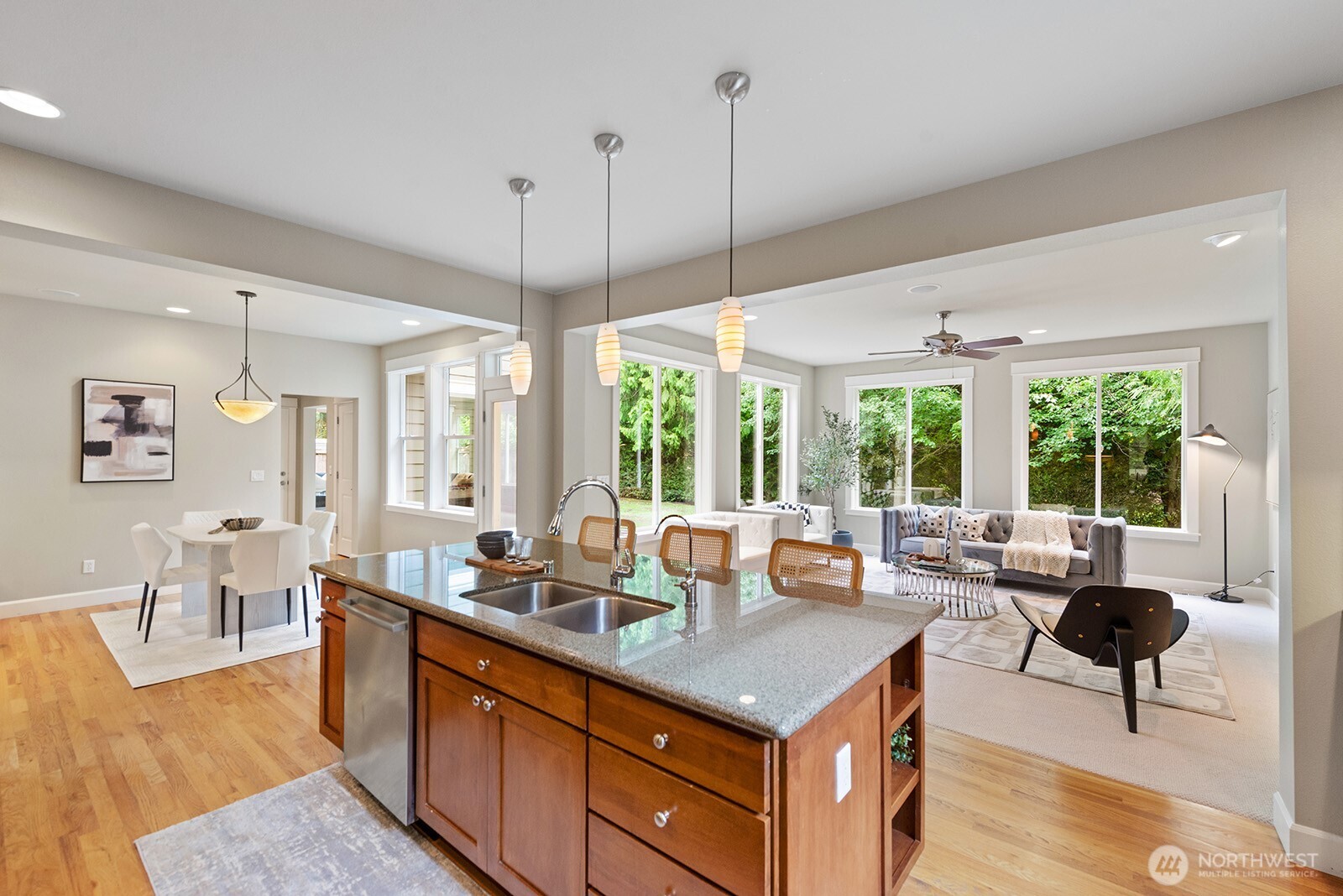 The chef's kitchen has SS appliances and overlooks the living room. The wall of windows overlook the peaceful scenery.