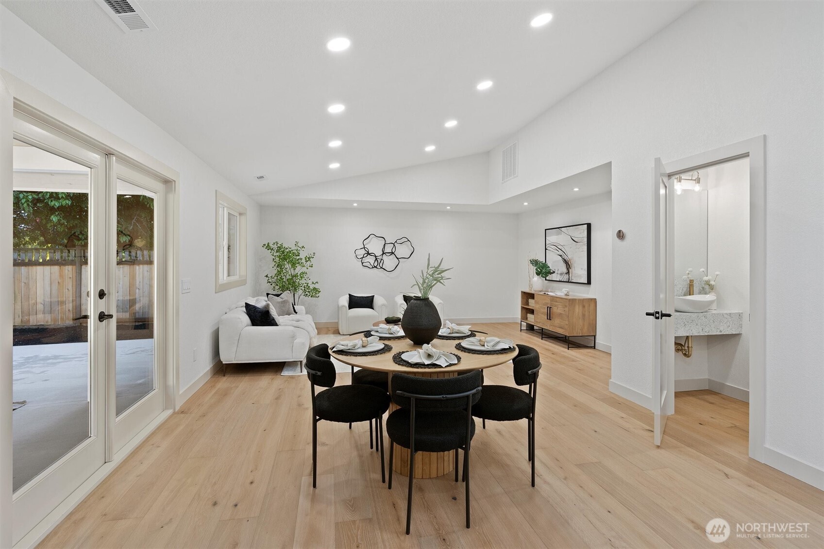 Vaulted ceilings soar overhead, creating an airy, light-filled atmosphere throughout the main living spaces.