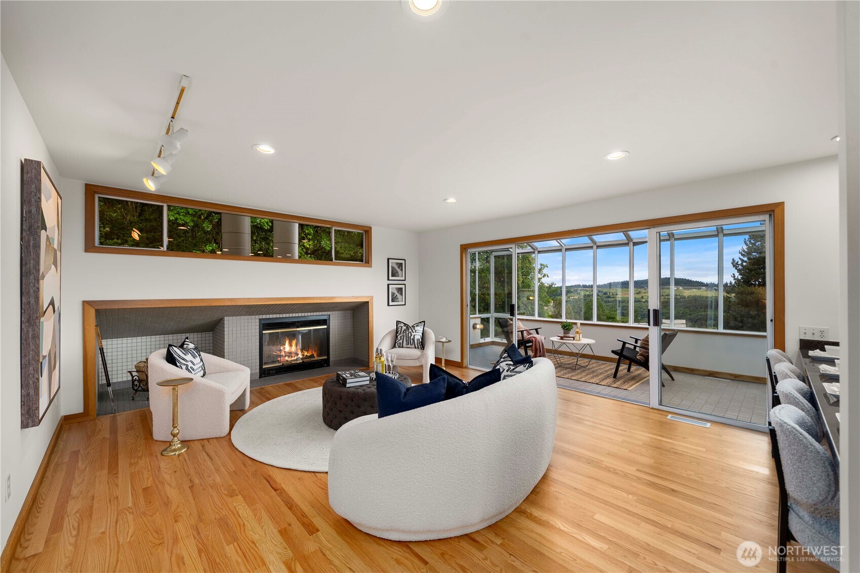 The inviting family room centers around a cozy fireplace and showcases framed views of majestic Mt. Rainier.