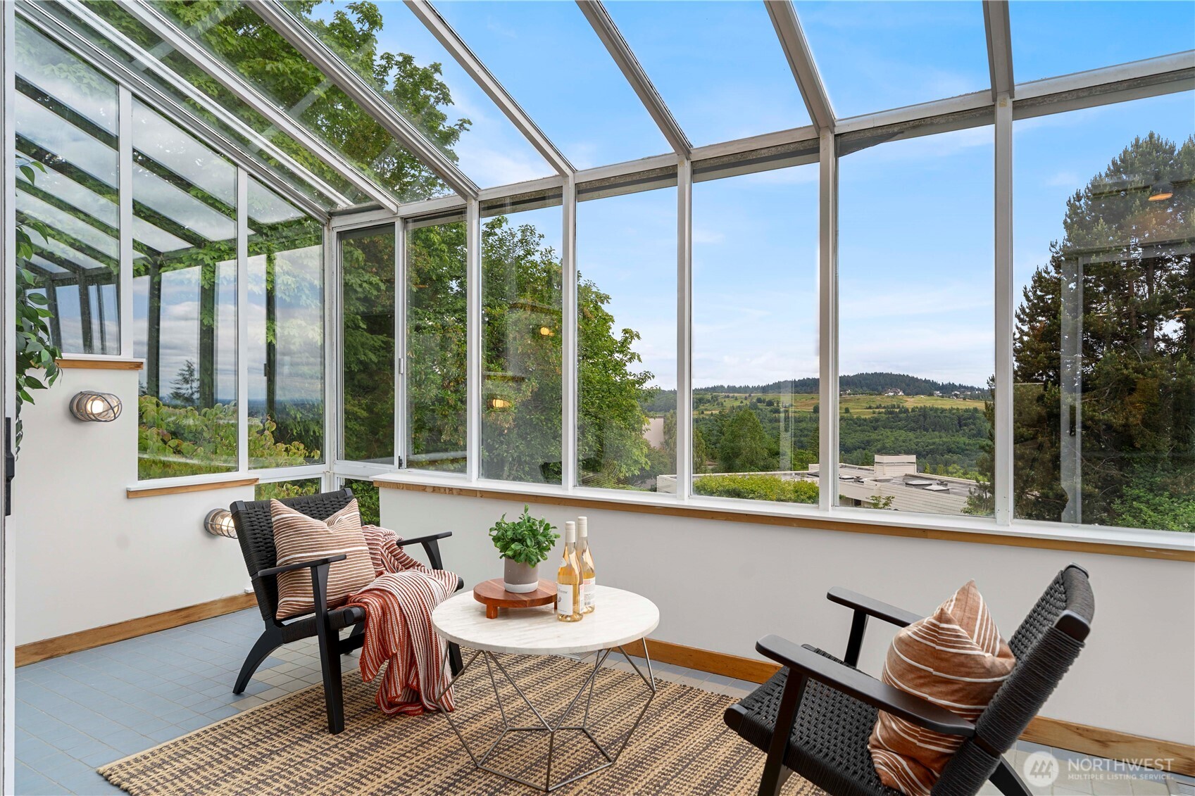 Bathed in natural light, the sunroom leads directly to the expansive deck—perfect for enjoying morning coffee with panoramic lake, city, and mountain views.