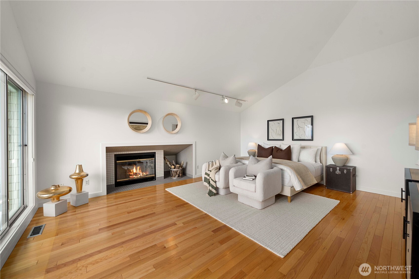 Retreat to a spacious master bedroom with direct access to a private view deck, offering a serene escape with breathtaking views.