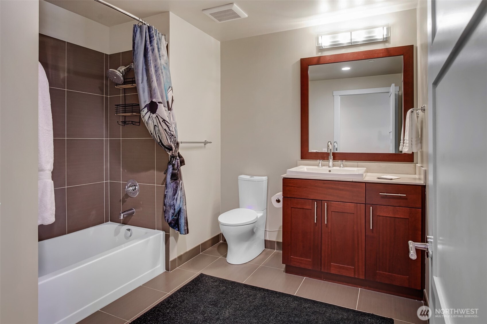A well-dressed full bath with new toilet/bidet and handsome fixtures.