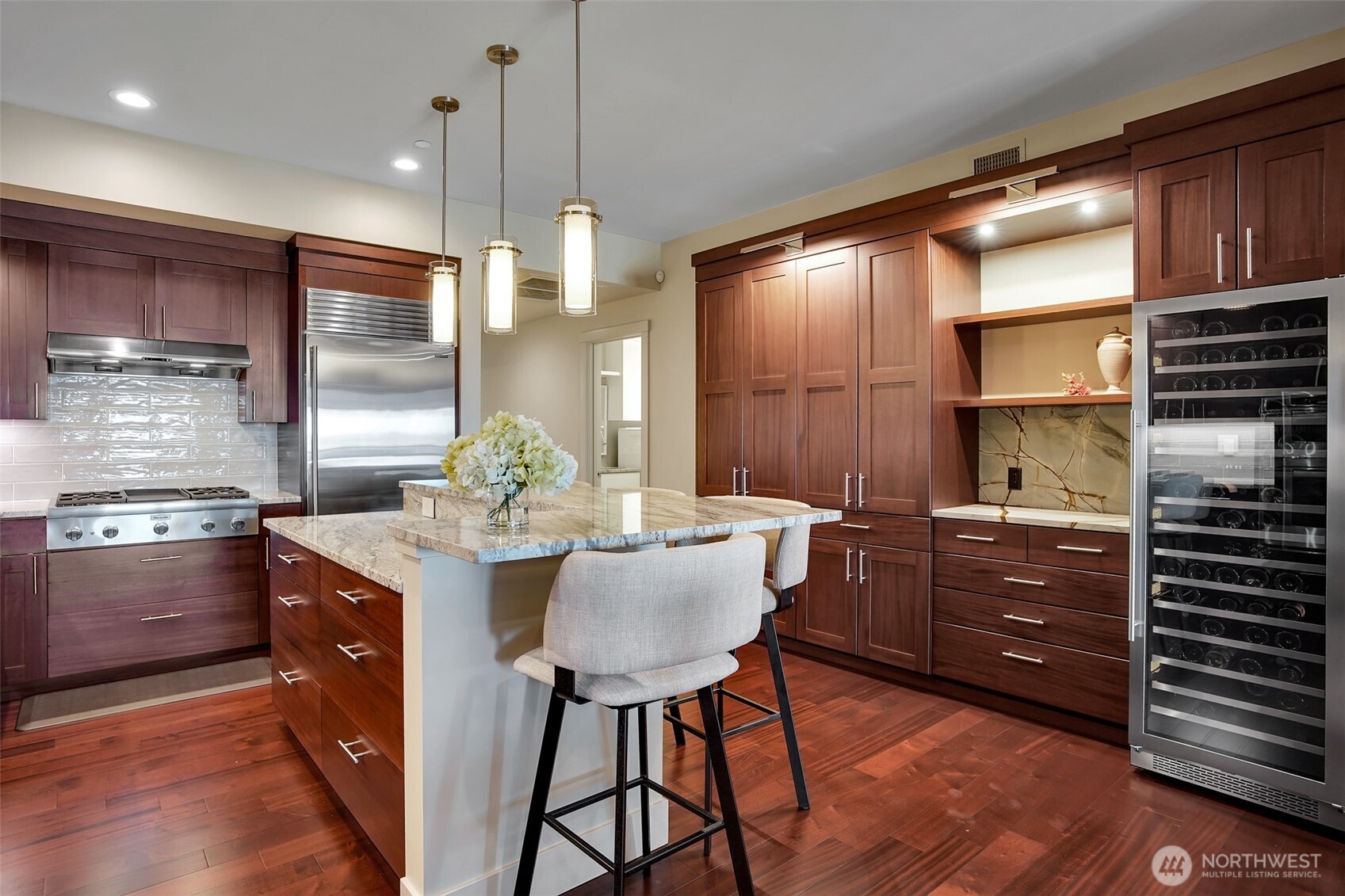 A stunning gourmet kitchen is sure to impress the chef in the house. From sleek cabinetry, granite countertops, to high-end appliances, cooking in this kitchen will be a delight. Don't miss the built-in 120 bottle wine cooler!