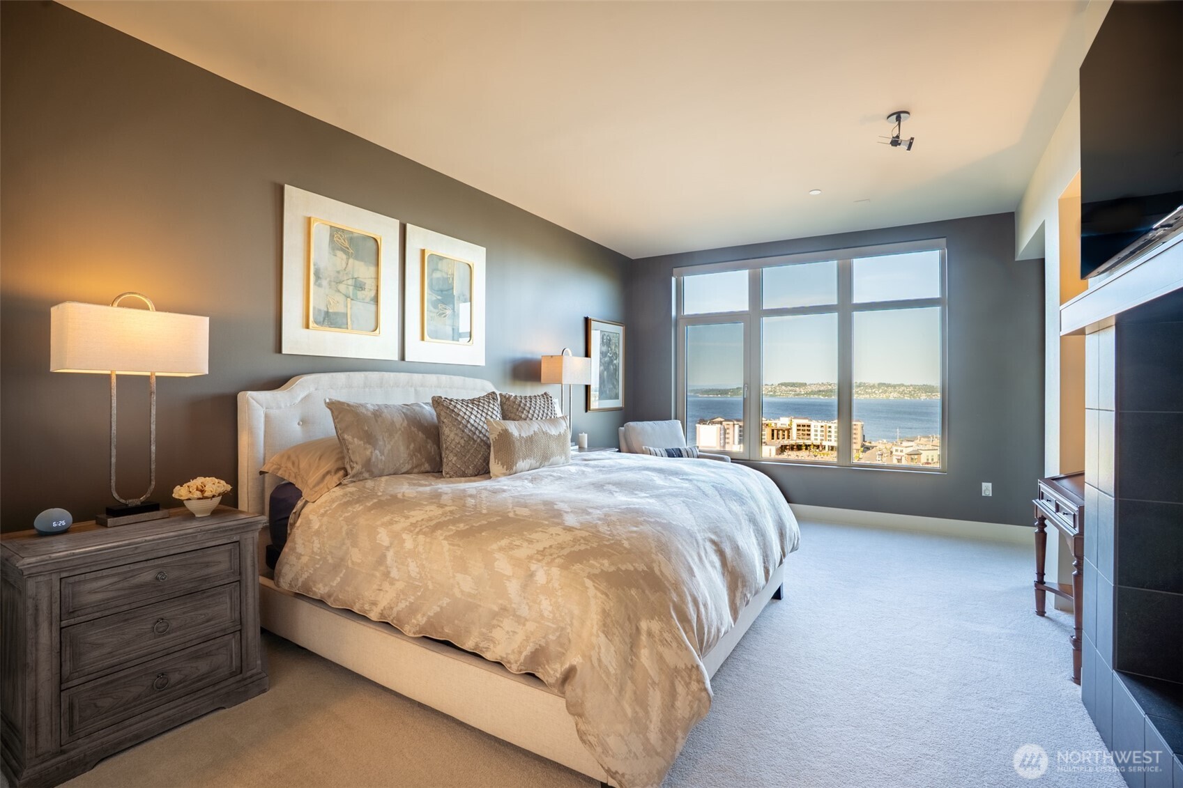 The primary bedroom will be your own personal retreat as you enjoy the other side of the dual sided fireplace and complimentary views of Commencement Bay.