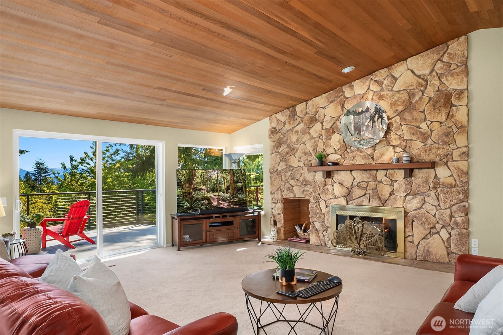 The cedar ceiling offers a fantastic vault - the wood burning fireplace is a focal point.