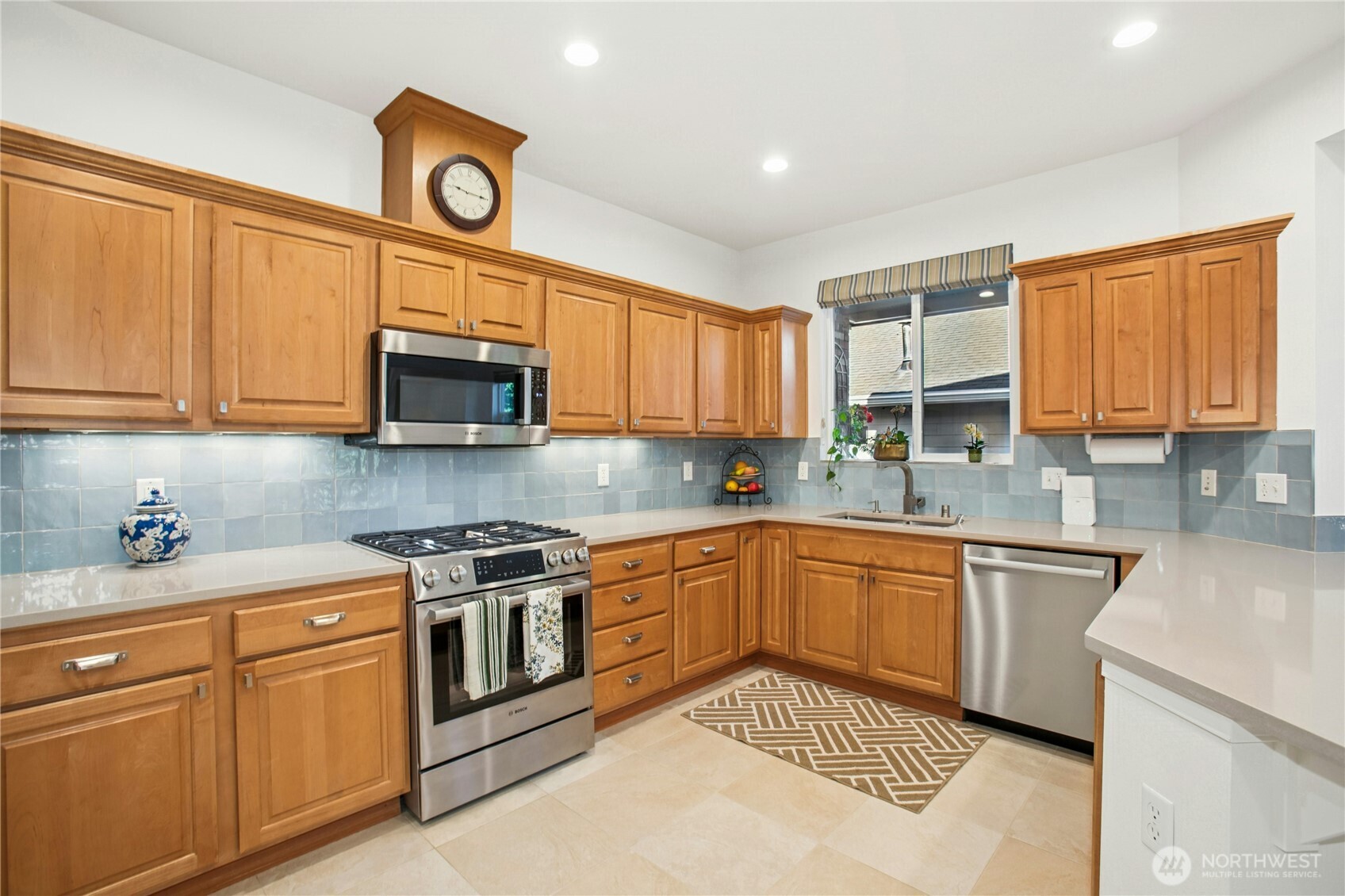 The remodeled kitchen features, new appliances, quartz countertops, tile backsplash, new sink and faucet