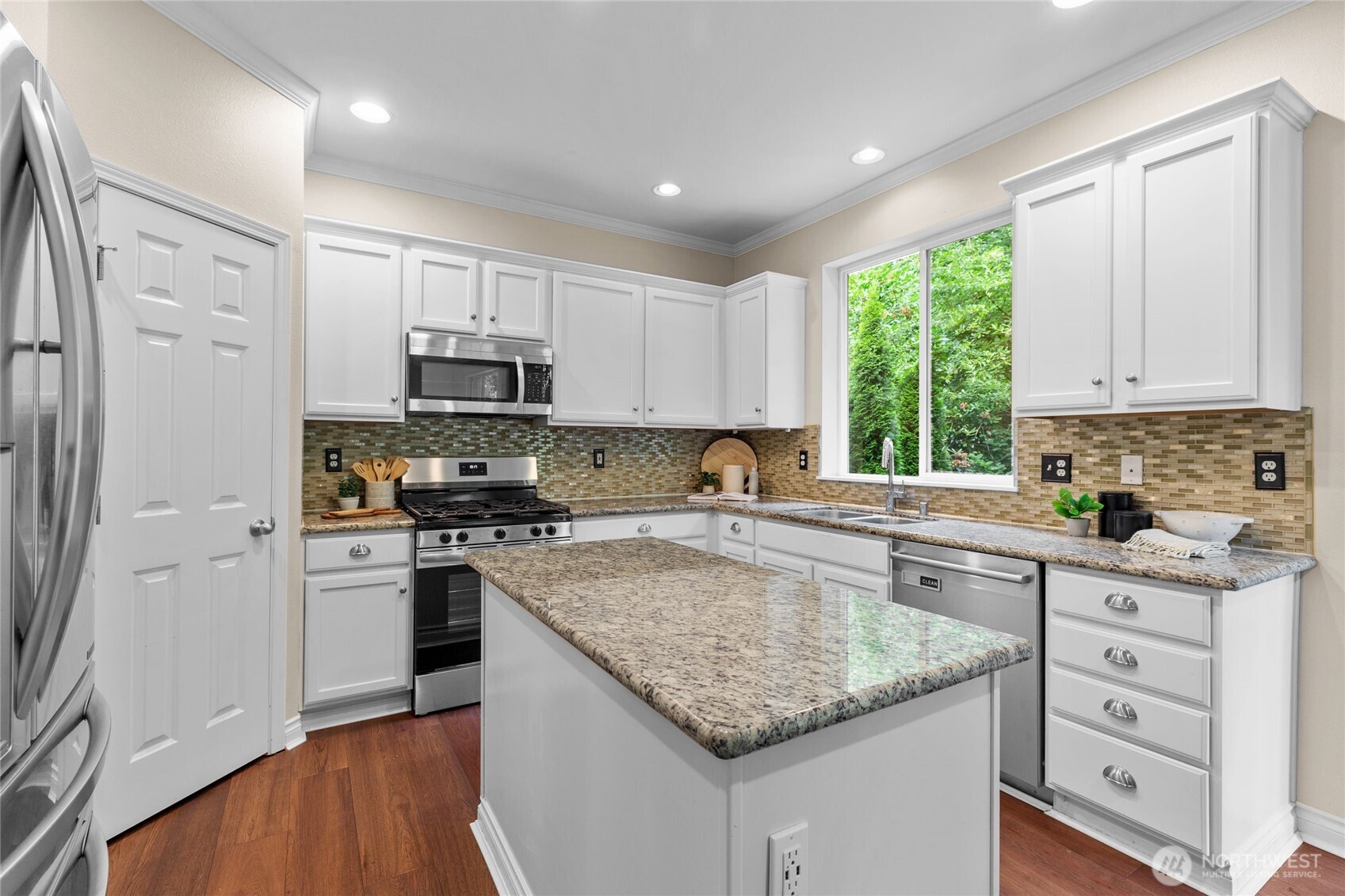 Mosiac tile backsplash. Bright and functional. Walk-in pantry.
