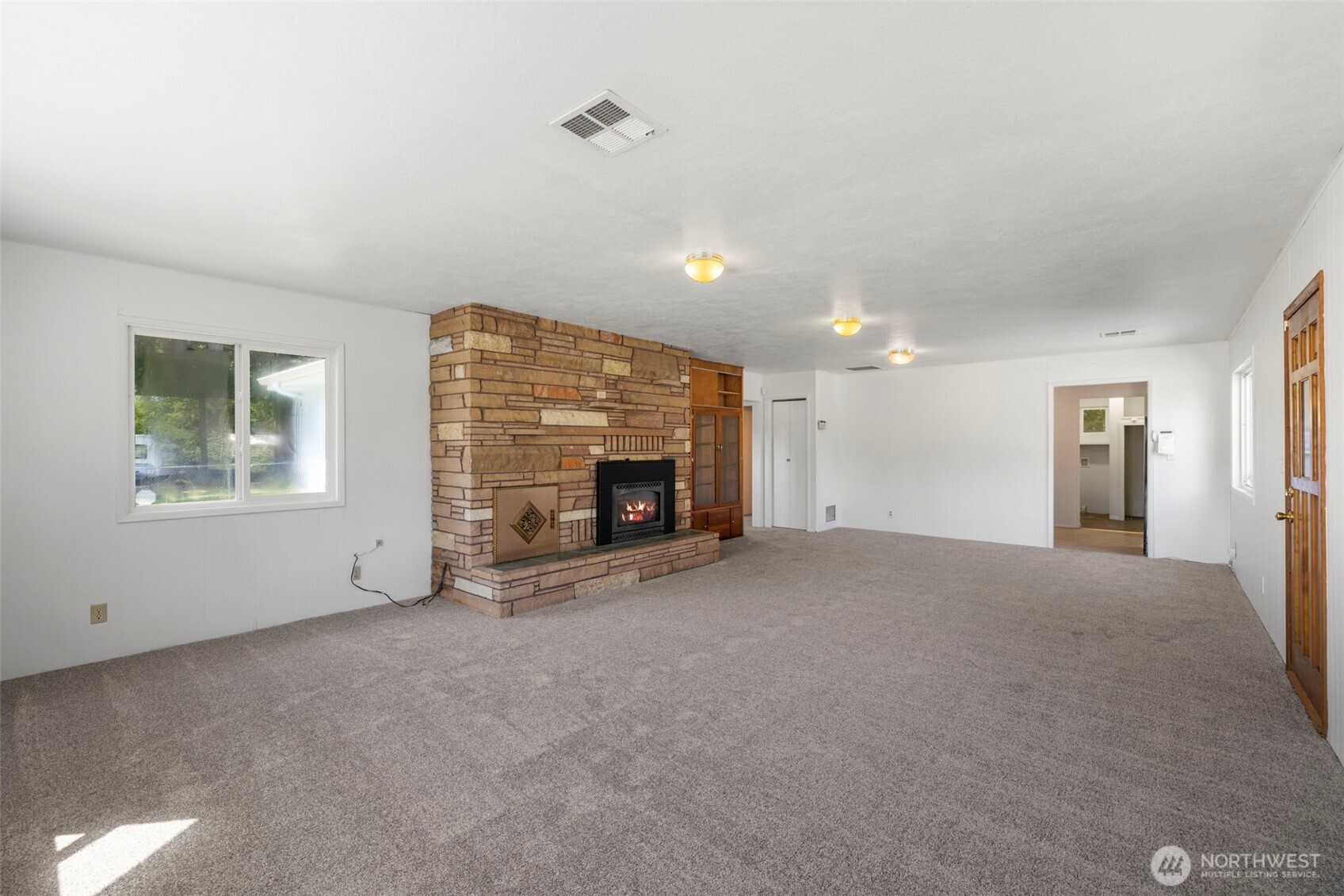 Beautiful stone fireplace will keep you cozy in winter.