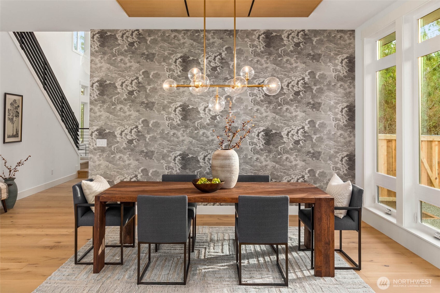 Stunning designer wallpaper feature wall and custom built rift oak ceiling detail create a dramatic dedicated dining space