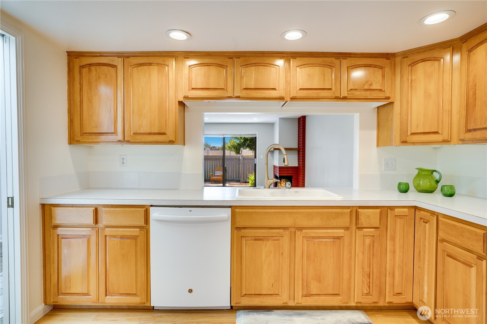 Eating nook to the left with a large window that looks through the entrance. Abundance of cabinets for storage.