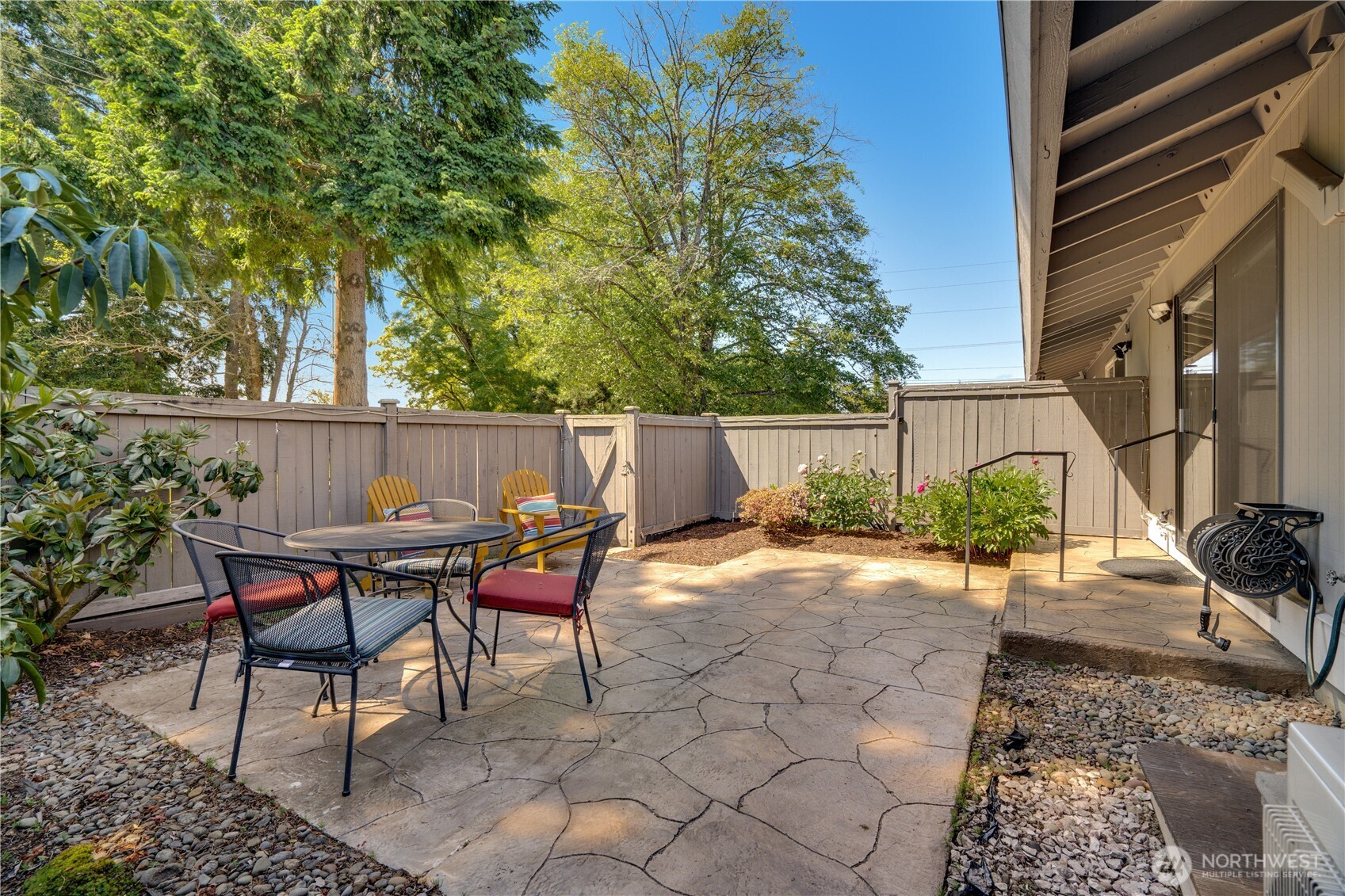 Backyard patio is fully fenced and backs to green space. Stamped concrete and mature plantings, Rhodes, Azaleas and Peonies are freshly in bloom.