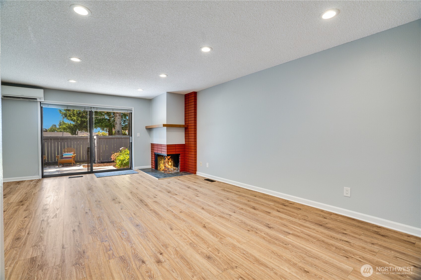 View of corner fireplace and dining area.