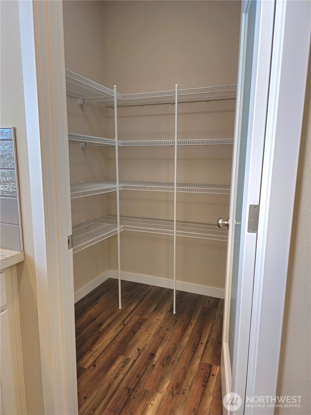 A glass door leads to a walk-in pantry.