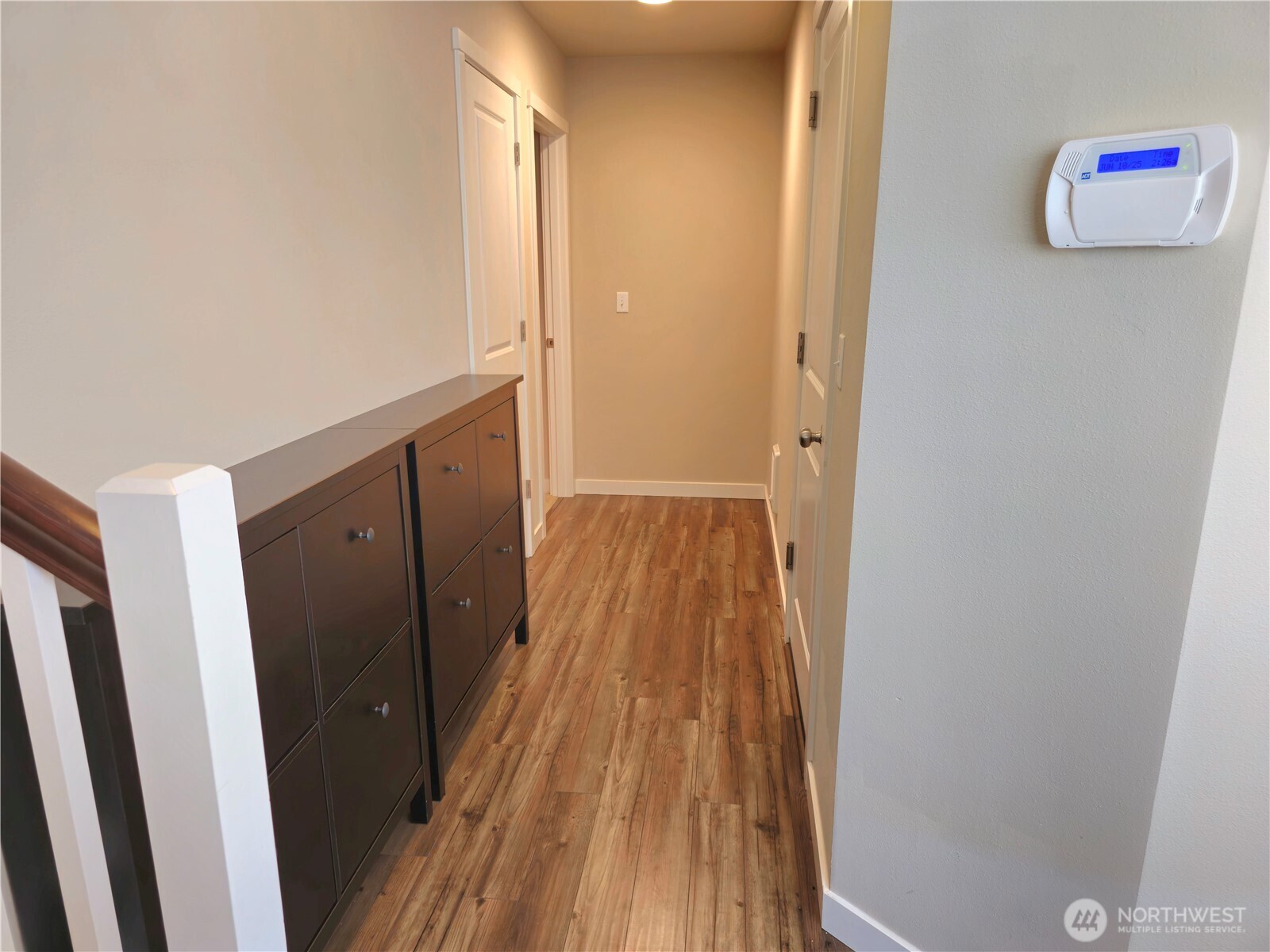 As you enter, the garage is conveniently located at the bottom of the stairs. The ground-level suite is to the left.