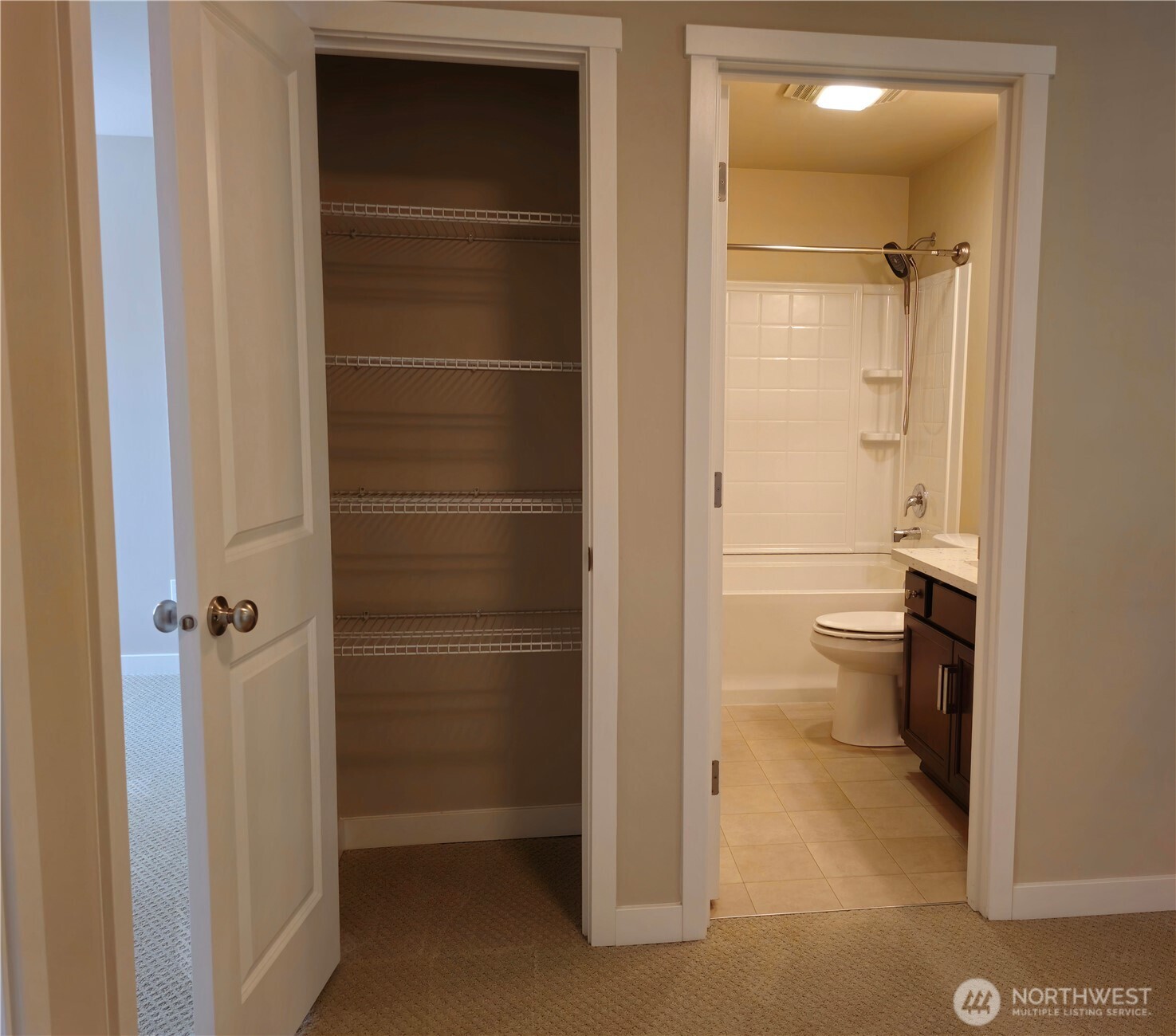 The linen closet has ample storage.