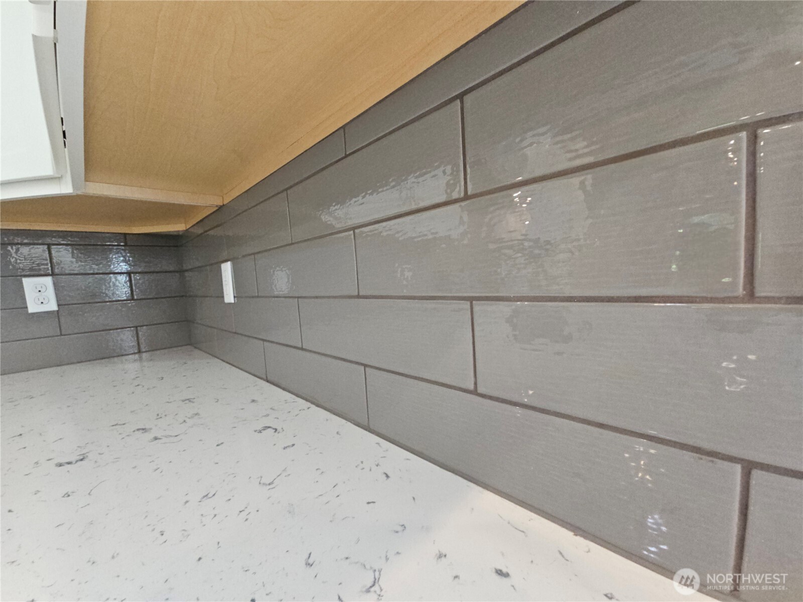Beautiful neutral, gray, glossy backsplash!