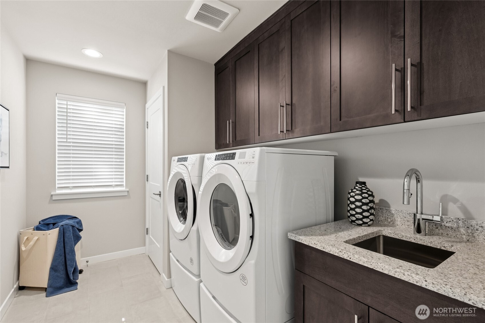 Laundry room connects to primary suite. For representation purposes only colors may vary.