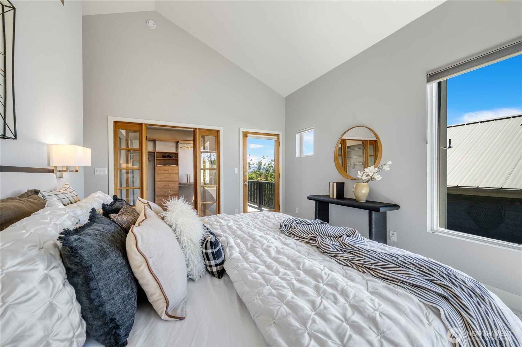 The first of 2 walk-ins in the primary is pictured here along with the access door to the second floor balcony.