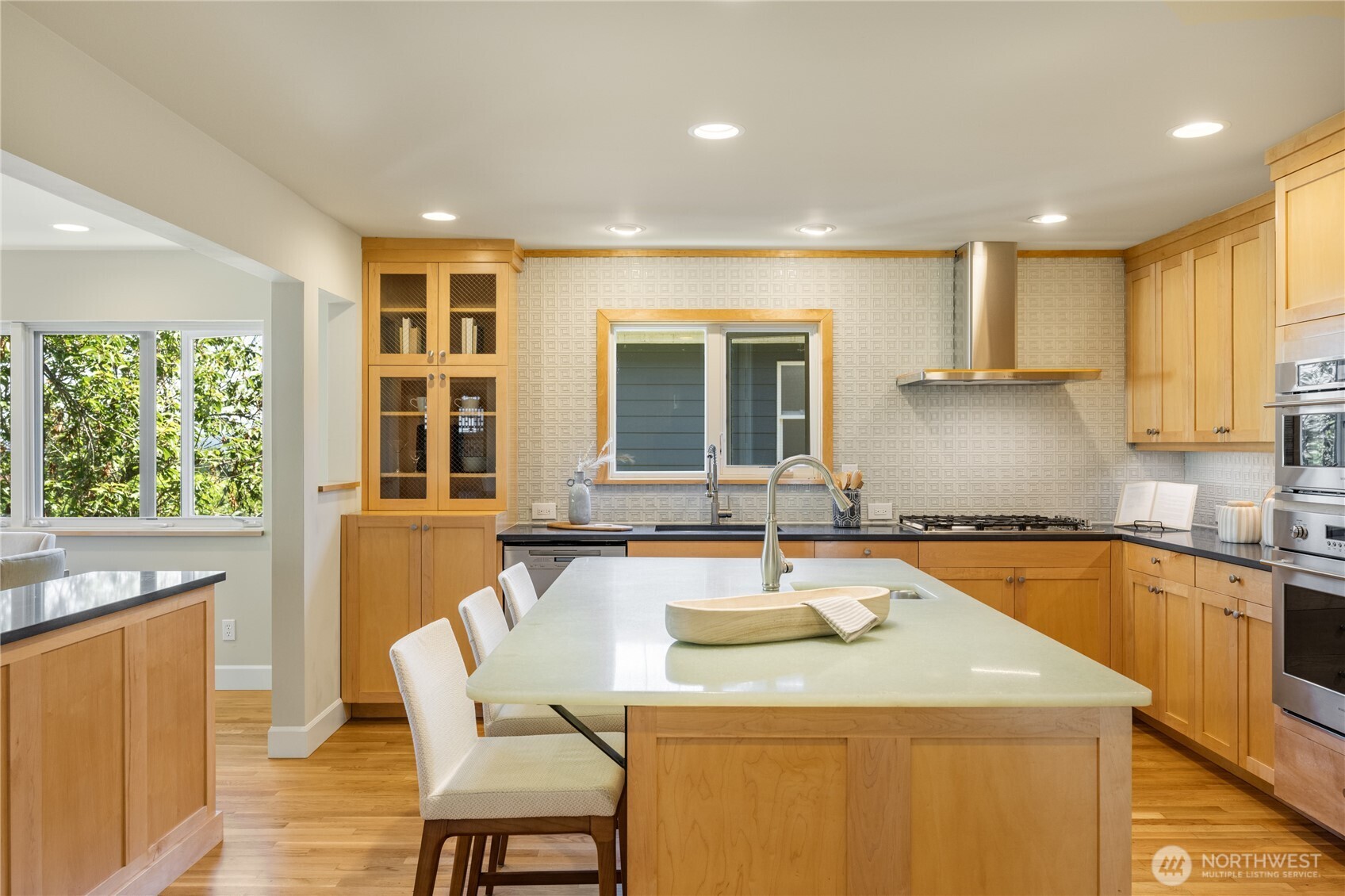 Stunning chef's kitchen with artisan tile backsplace, quartz and molded glass countertops and high end appliances