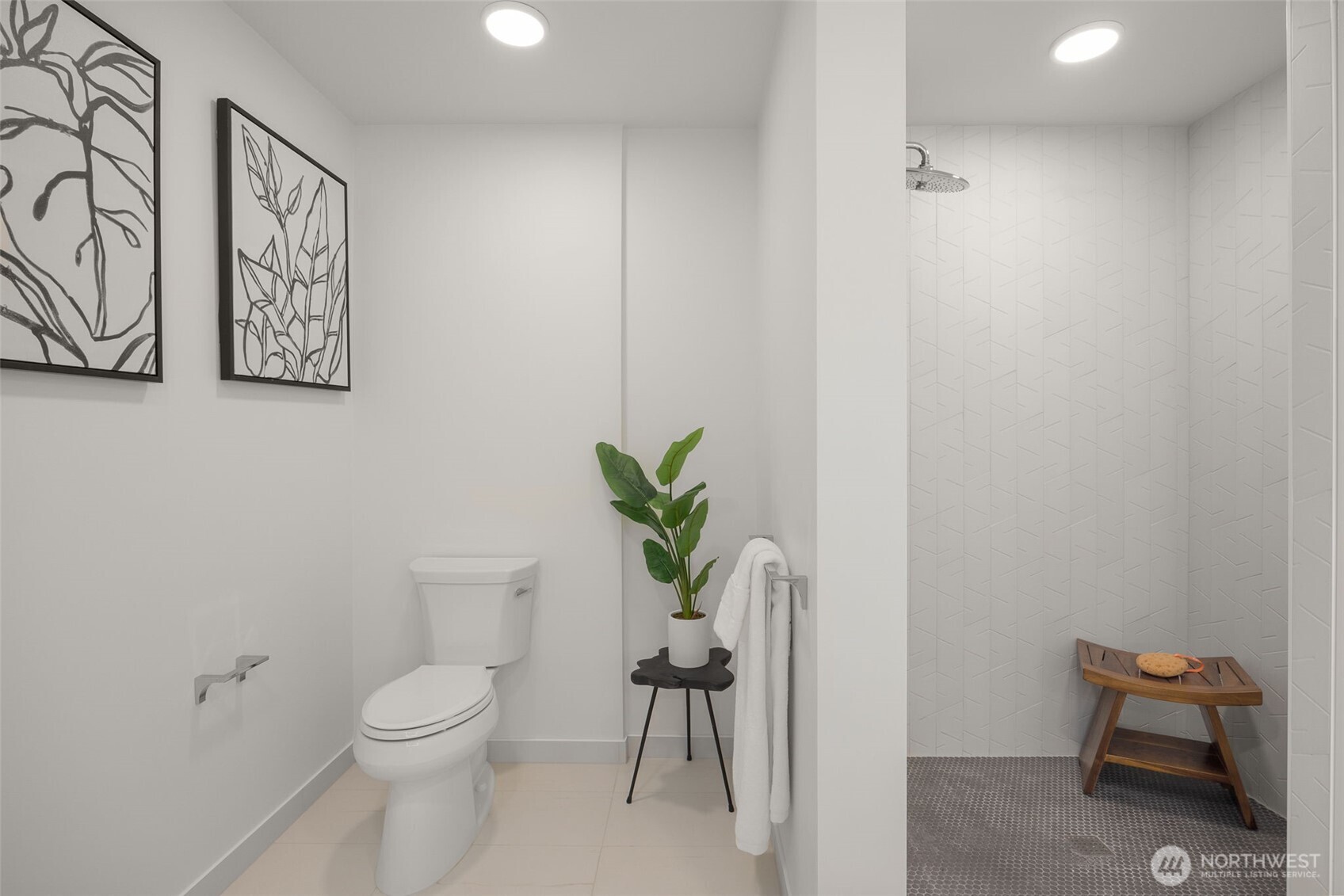 Bathroom features an ADA compliant ceramic tile shower