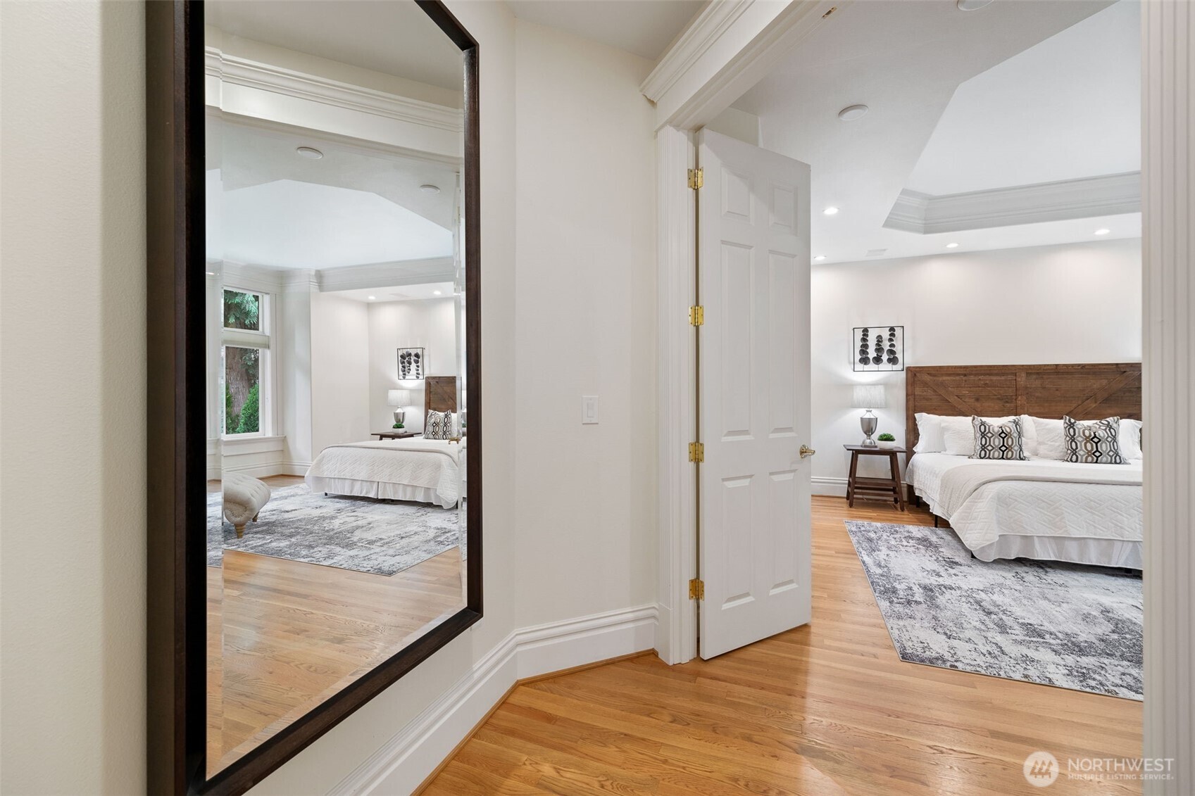 Main floor primary suite with hardwood floors.