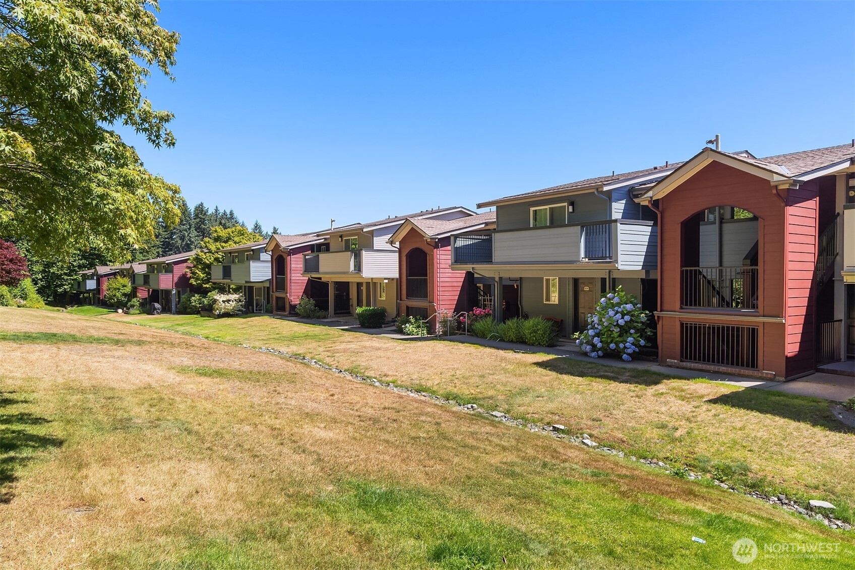Great lawn behind complex, and private greenbelt with trails.
