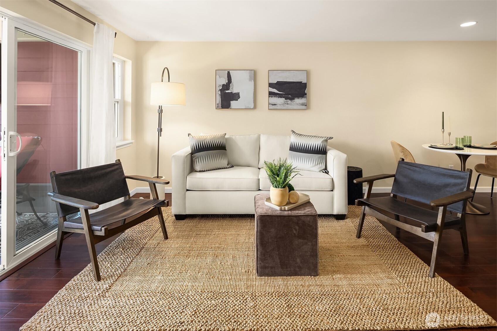 Light and bright living room with sliders to deck. With doors open it feels like you are bringing the outdoors in. Open floor plan for living room, kitchen and dining.