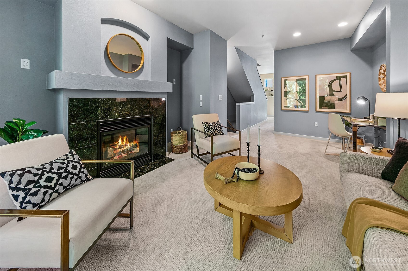 Anchored by a fireplace, the living room also has high ceilings and fresh paint and carpets.