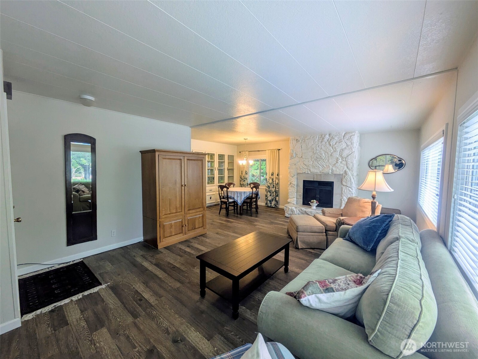 Large living area with beautiful floors and picture windows.
