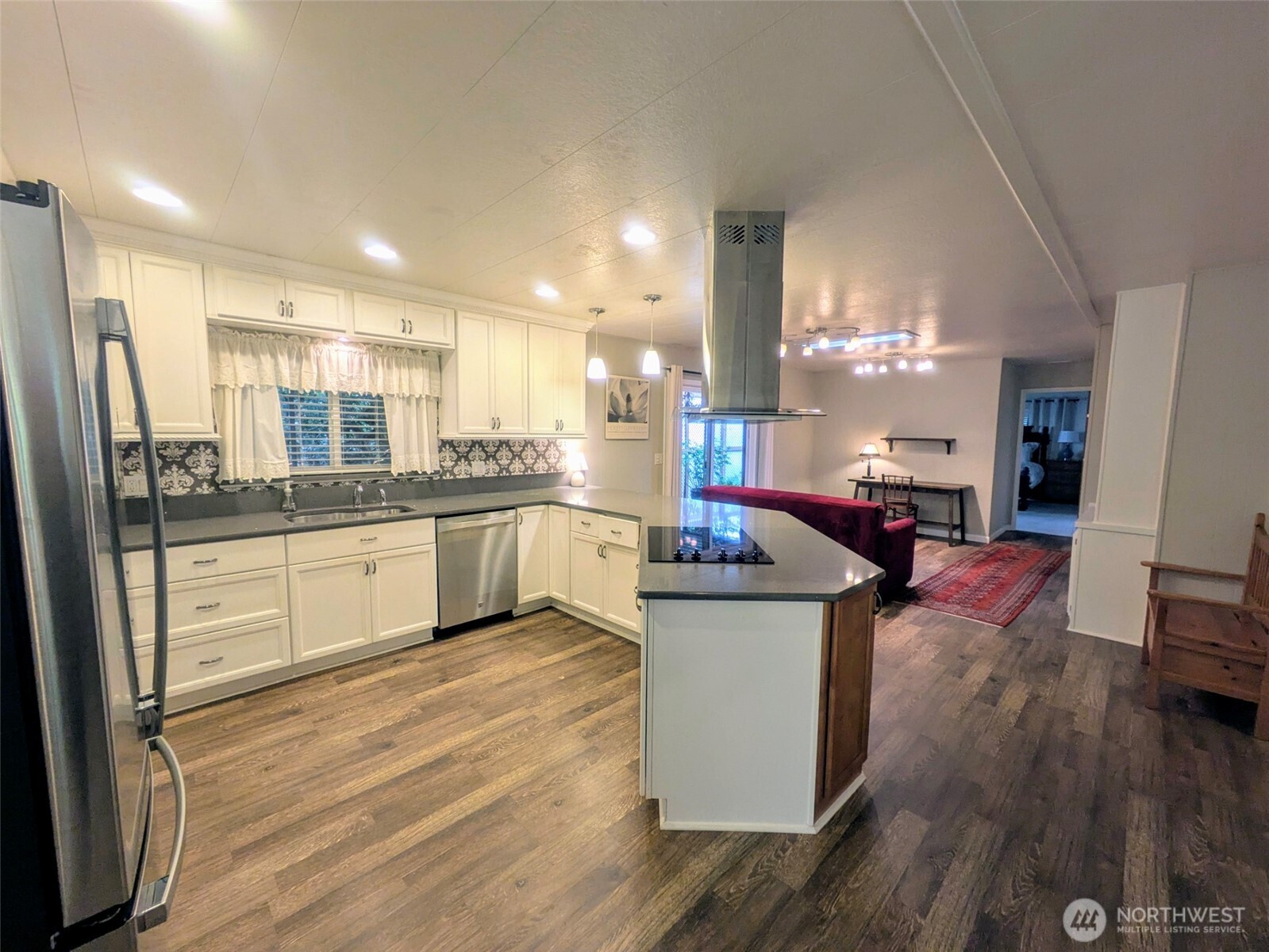 Open concept kitchen to family room. Updated lighting and beautifully updated kitchen with Quartz and stainless-steel appliances.