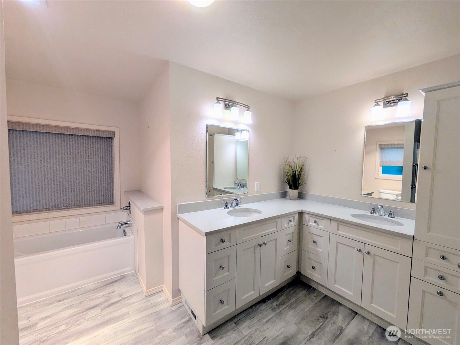 Primary bathroom showing double sinks and tastefully updated with extra storage cabinets.
