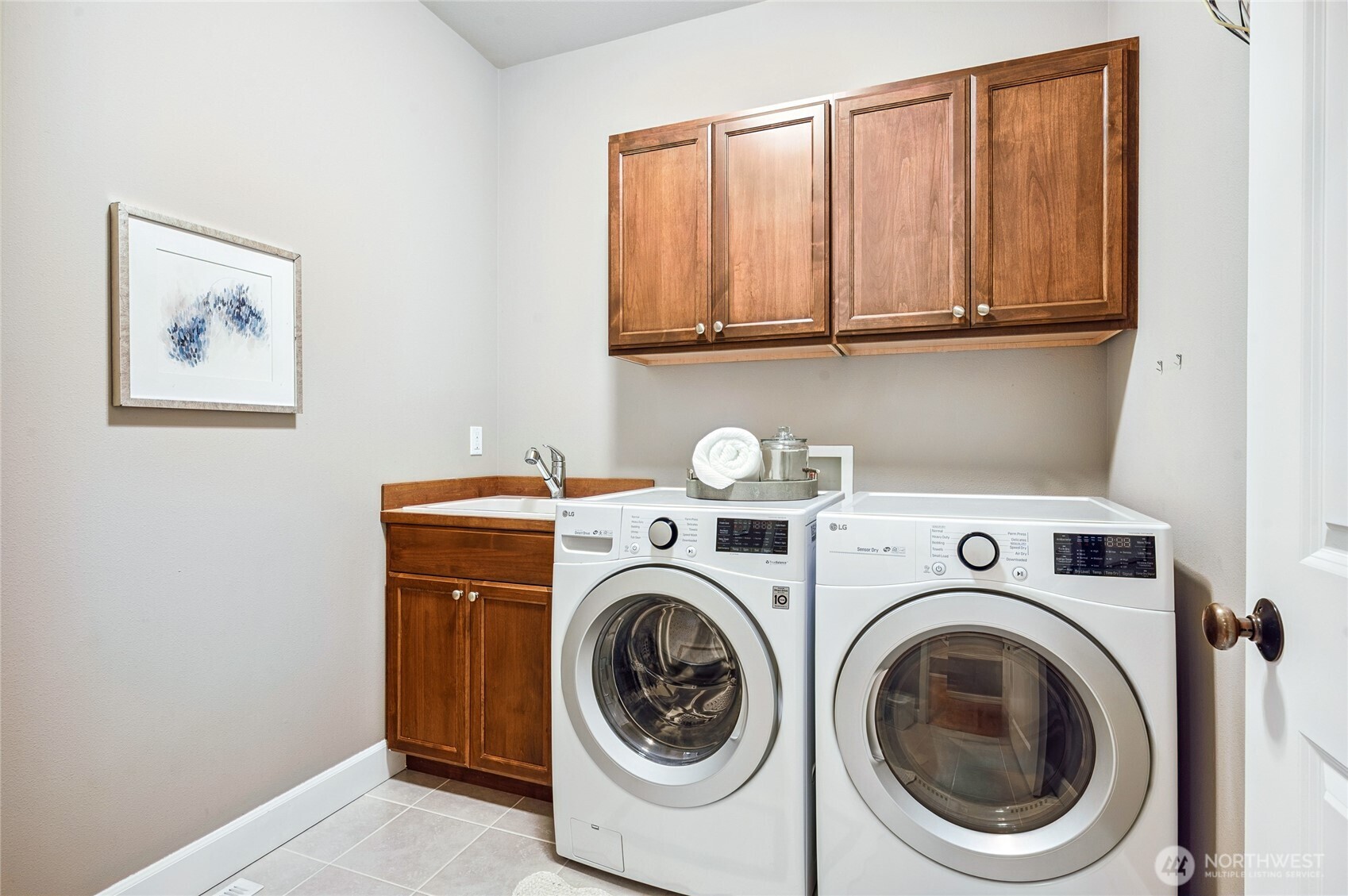 Laundry room with convenient utility sink.