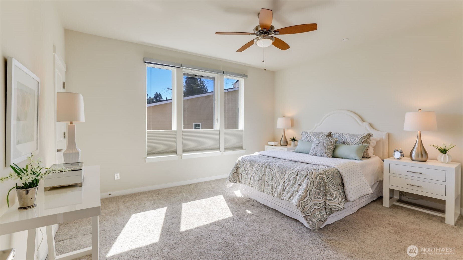 The primary bedroom is spacious with a ceiling fan and a walk-in closet.