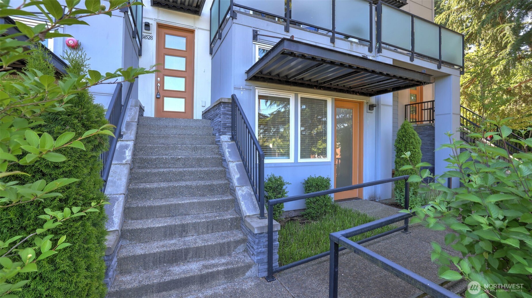 This is the front of the home. 14528 is the home address. The door to the potential business is on the right. The overhanging deck is above with a view of the local area.