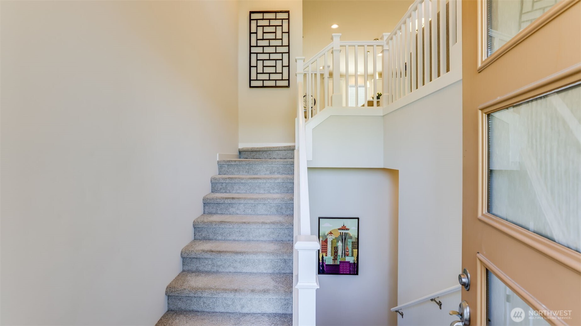 Looking from the front entrance you see a wide open set of stairs up to the main level and to the right there is stairs to the potential business room and the garage.