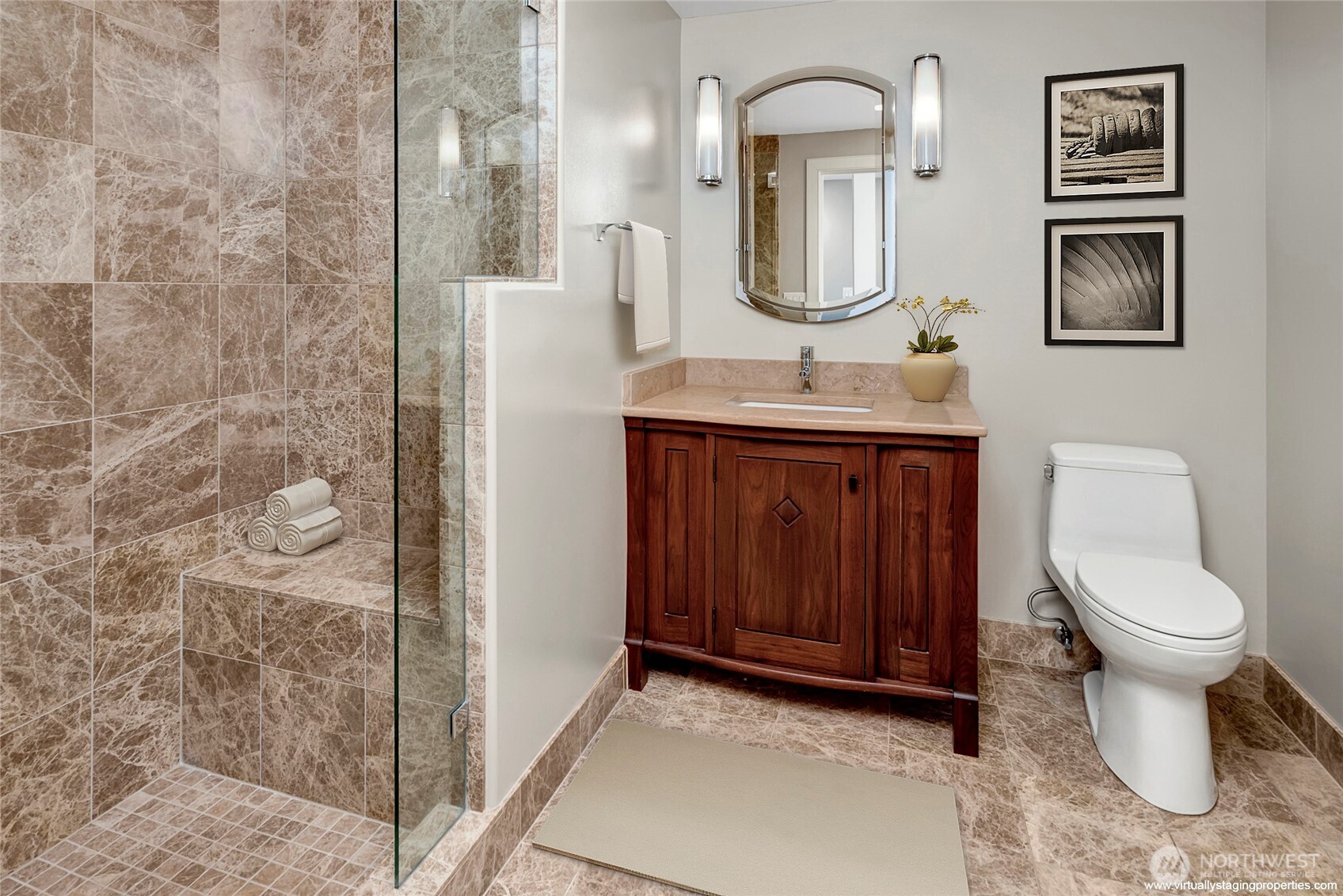 Main floor guest bathroom with beautiful granite shower and floor, with bench. Custom cabinets and stone cabinet topl