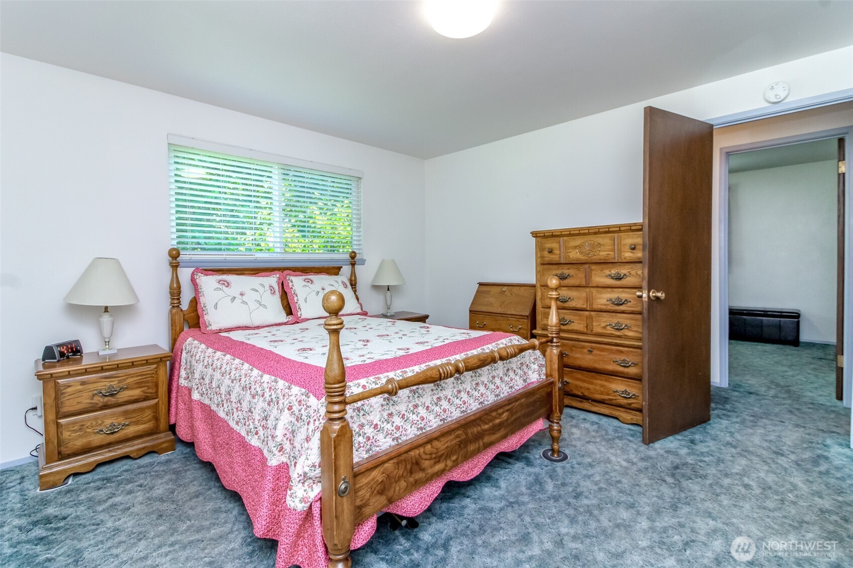 Primary bedroom with 3/4 attached bathroom. Hardwood floors under carpet have been covered since 1970's