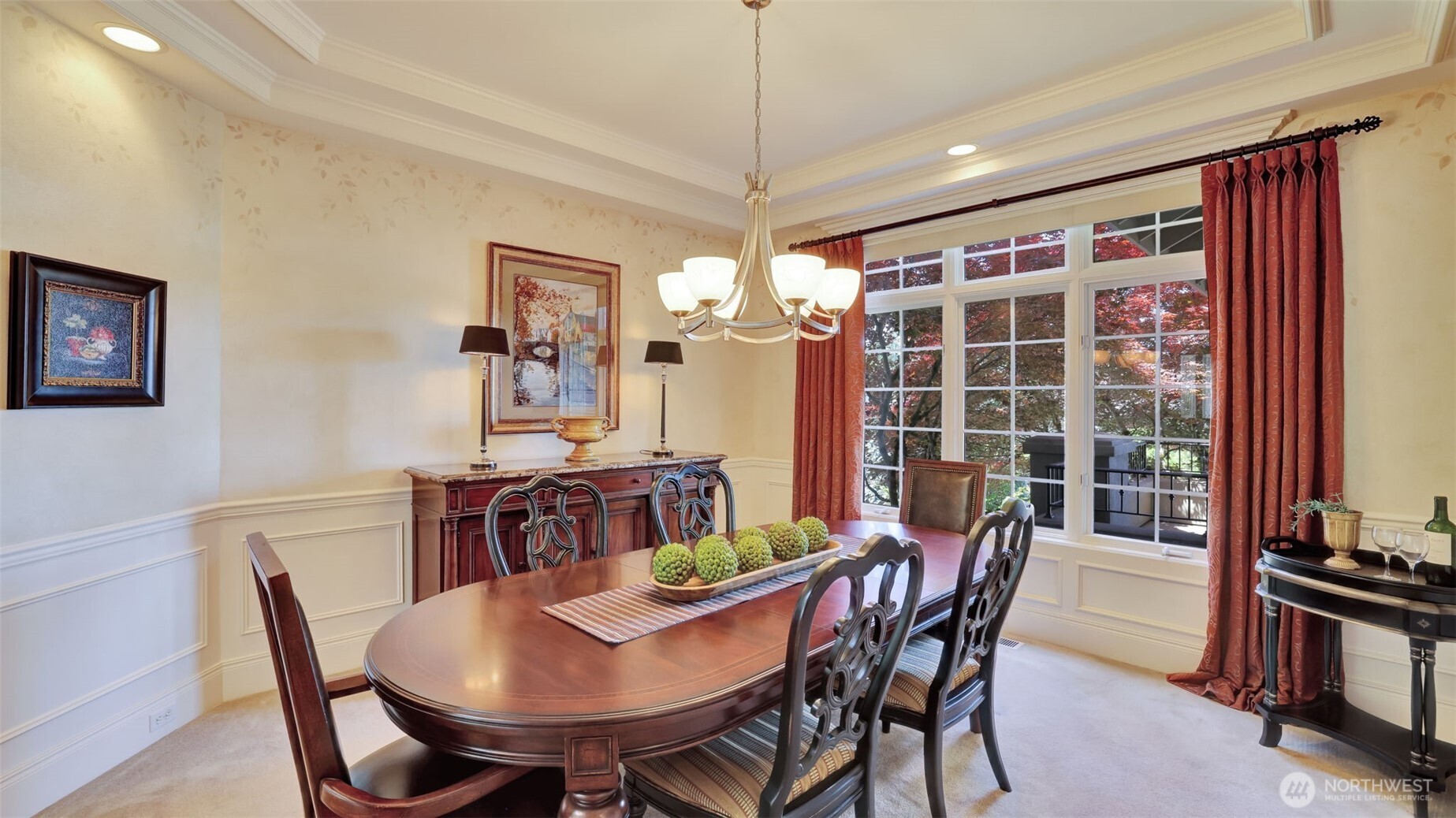 Dining room with stepped ceiling and crown molding details.