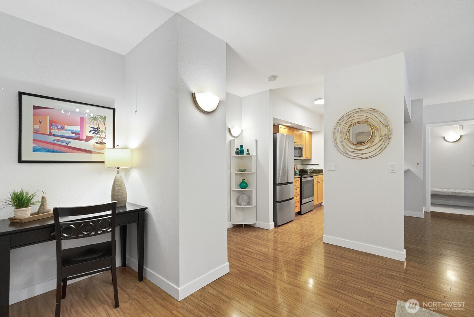 Enter to gleaming wood floors, beautiful lighting and a lovely open floor plan.