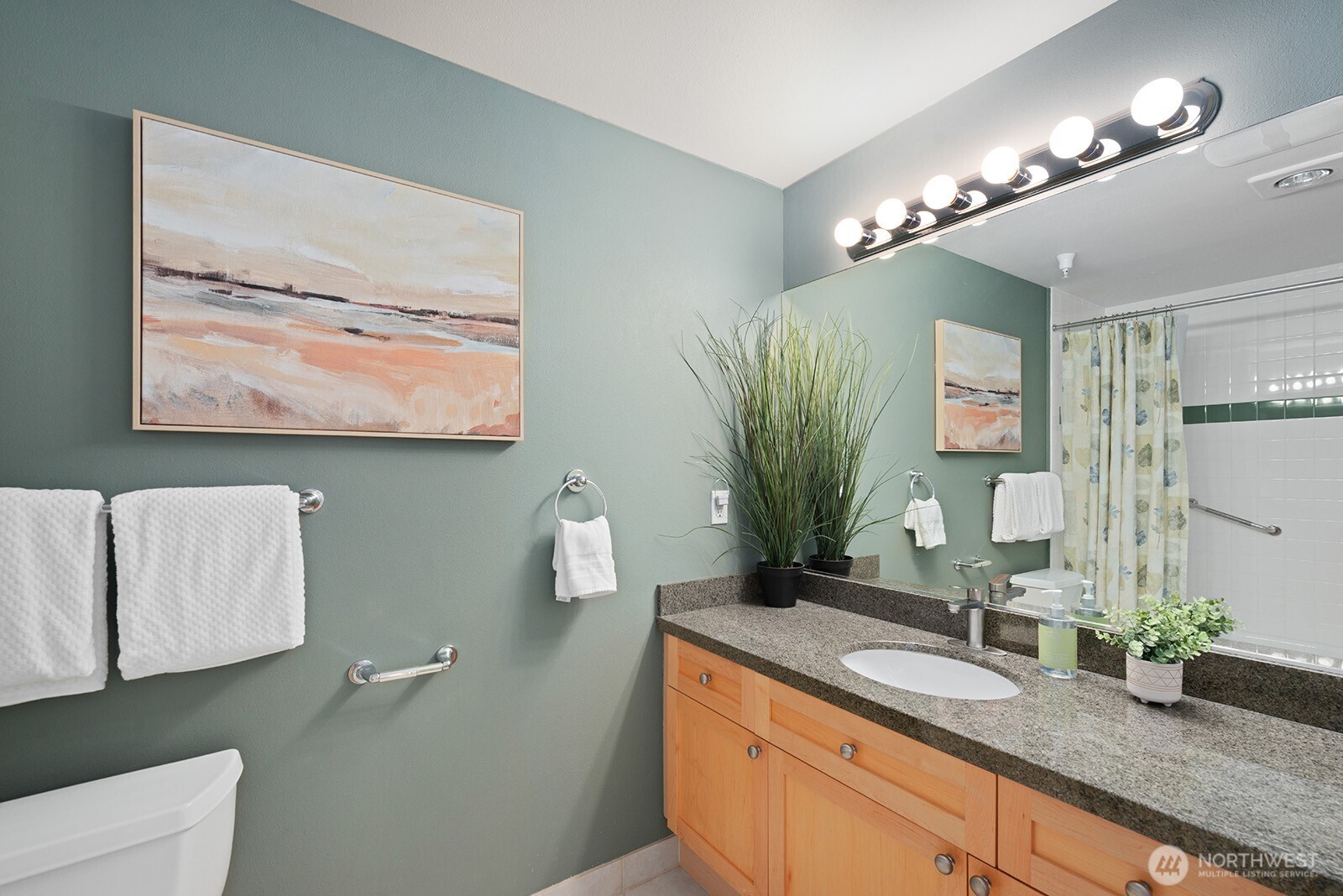 Ample counter space and cabinets in the full guest bath.