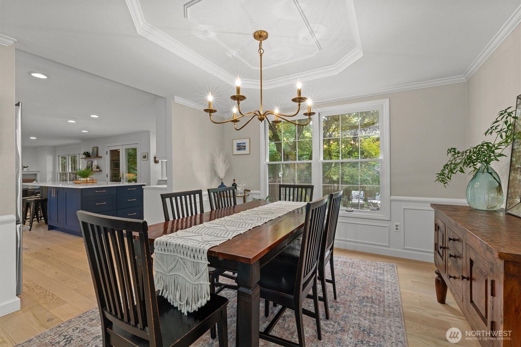 The perfect formal dining room meets the A+ kitchen. Plenty of room to entertain, enjoy the beautiful view of the back yard. The Brass Lucca Iron Chandelier is a favorite!