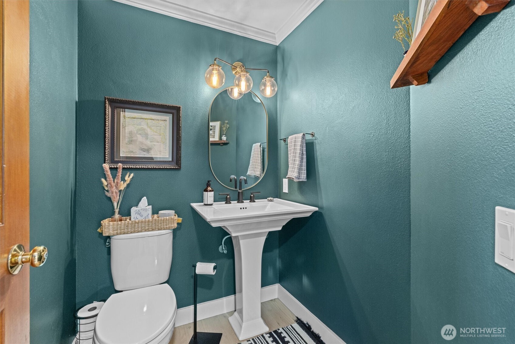 The sweet powder room on the main level, the pedestal sink is a great touch. All toilets were replaced in this home during the remodel.