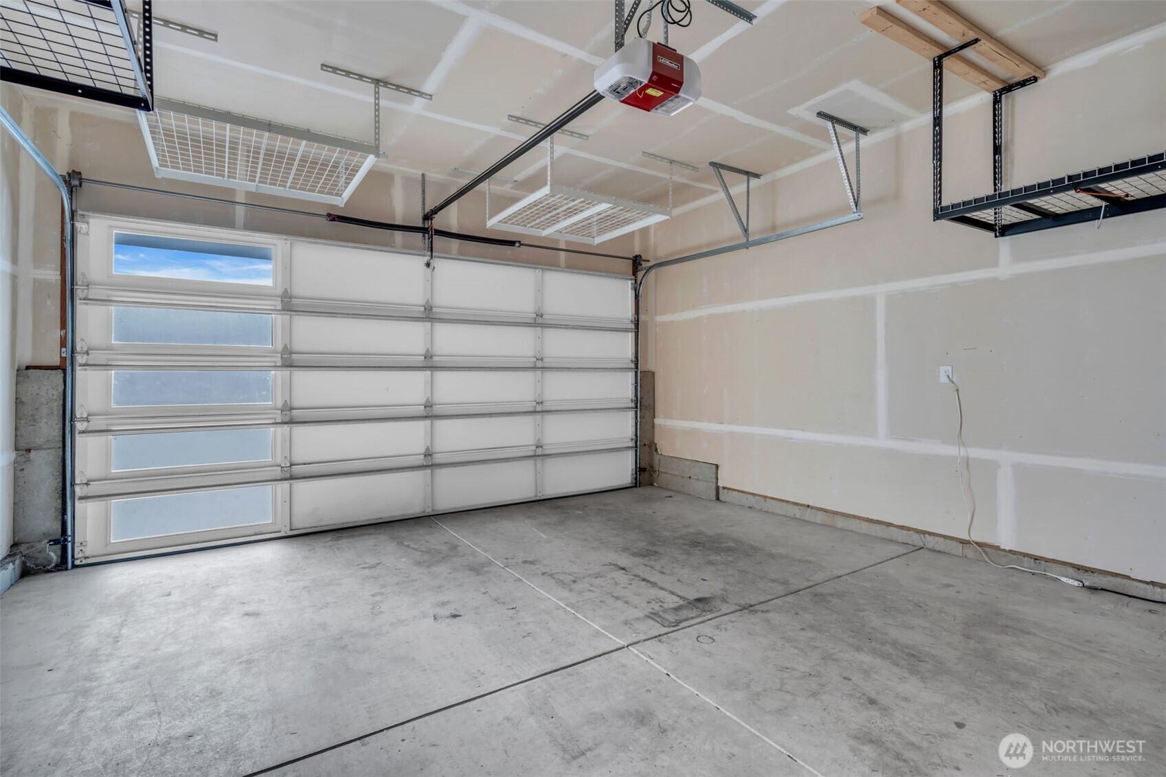 Oversized double car garage with ceiling storage.